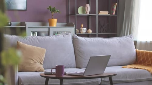 Comfortable Living Room Interior with Laptop and Mug