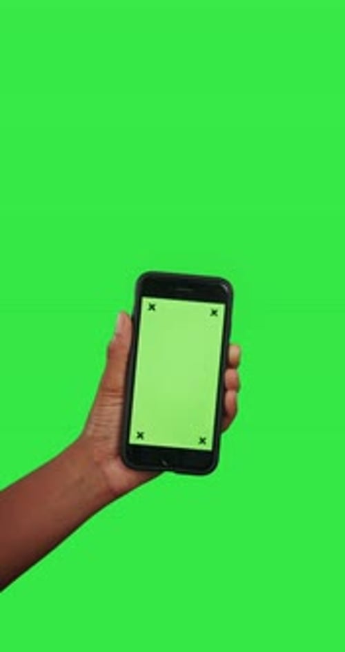 Hands, phone and mockup green screen with tracking markers for advertising against a studio