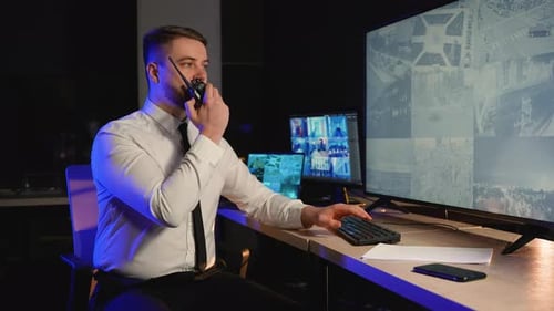 Security Guard Monitoring Cctv Footage in a Control Room