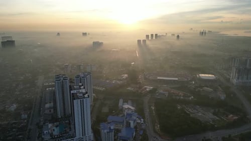 Aerial view misty morning Larkin city with a large building in the foreground