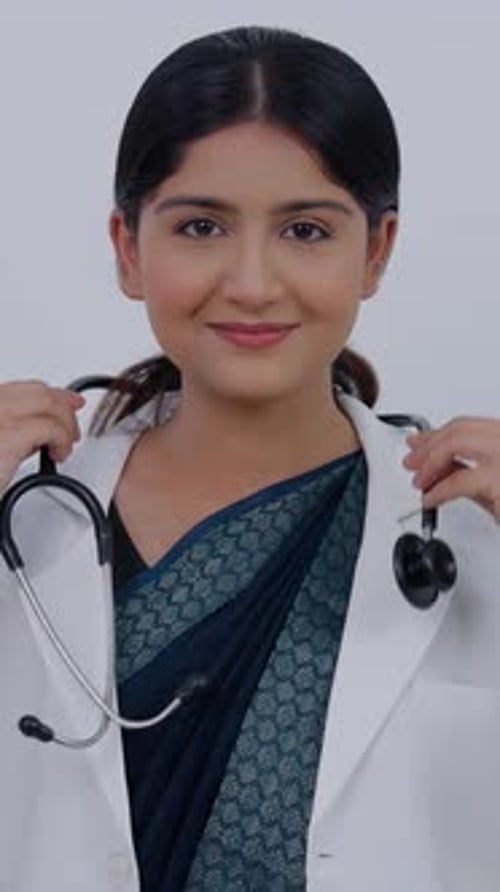 Vertical Video of Indian Female Doctor Wearing Stethoscope and Smiling at Camera