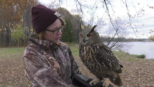 Woman Holding an Owl on a Fall Day
