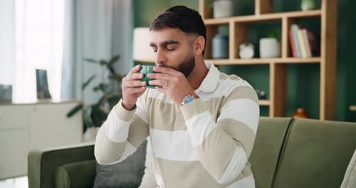 Young Adult Drinking From a Mug Indoors