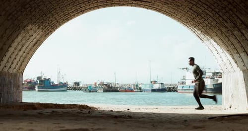 Running, fitness and man in tunnel by harbor for marathon training, exercise and cardio workout