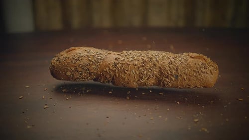Seeded Bread Being Placed on Table
