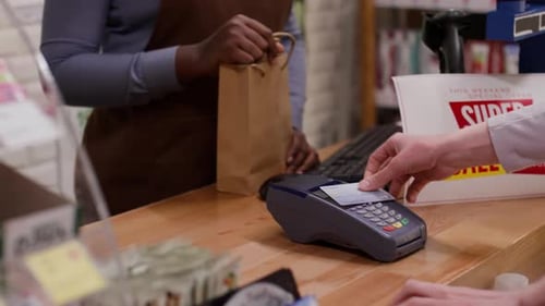 Woman Handing Customer a Shopping Bag