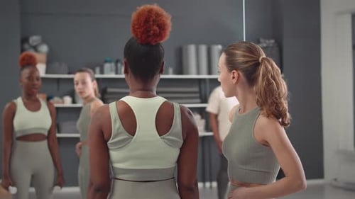 Woman Receives Fitness Training Assistance in Gym Studio