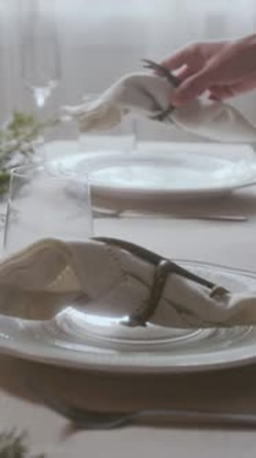Setting Elegant Table with Napkins and Dinnerware