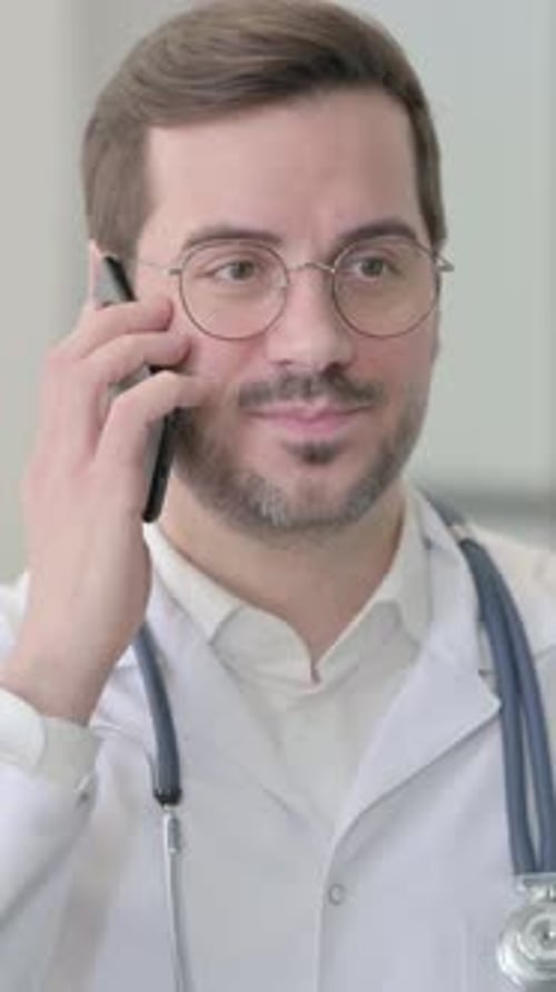 Professional Doctor Talking on Cell Phone in Hospital Setting