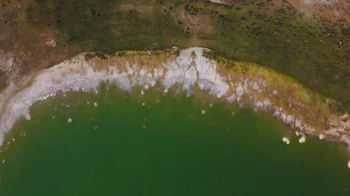 Salt at the waterfront of beautiful aquamarine waters. Circling over the bare shore of Mono Lake