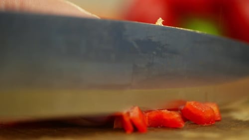 Woman Dices a Fresh Red Bell Pepper