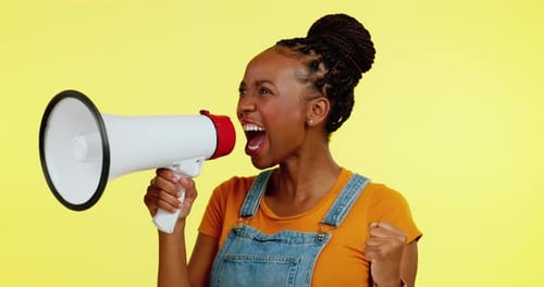 Excited Woman Yelling Into Megaphone on Yellow Background