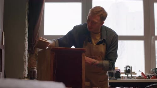Artisan Renovating Old Furniture in Carpentry Workshop