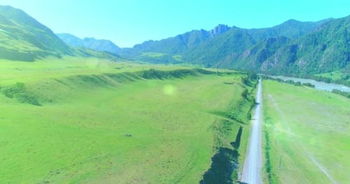 Aerial Rural Mountain Road and Meadow at Sunny Summer Morning Asphalt Highway and River