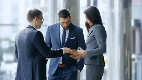 Business Team Discusses Tablet in Modern Office