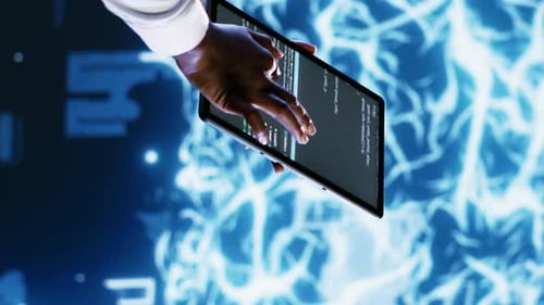 Hand Operating Tablet Showing Programing Code