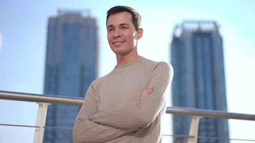 Young Man With Arms Crossed, Buildings in Background