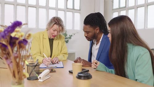 Financial Advisor Consulting Young Couple in Office