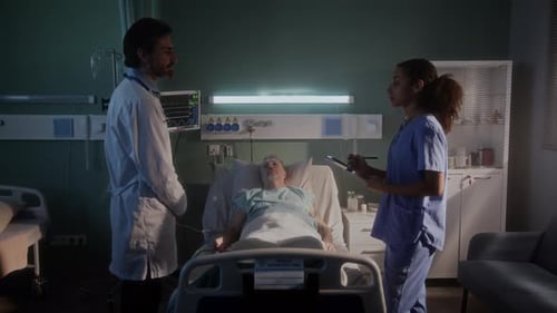 Doctor and Nurse Attending Patient in Hospital Room