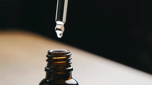 Dropper Filling Bottle with Liquid, Close Up View