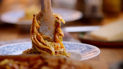 Serving Delicious Pasta onto Elegant Plate, Close Up