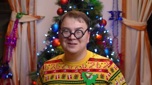 Smiling Man in Christmas Sweater and Novelty Glasses