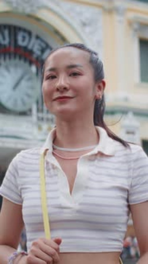 Portrait of Positive Asian Woman Walking in City Center