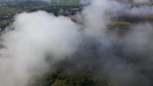 Aerial View From Above of Morning Fog Over Green Wooded Landscape