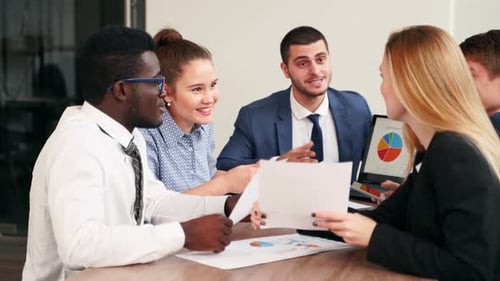 International Business Partners Discuss Financial Project Results on Meeting in Office Multiethnic