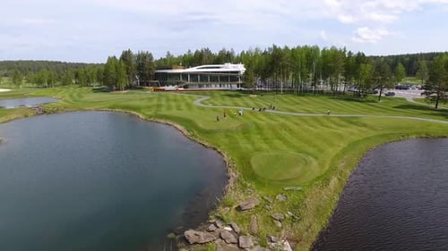 Captivating Aerial View of a Beautifully Designed Golf Course Surrounded By Lush Nature