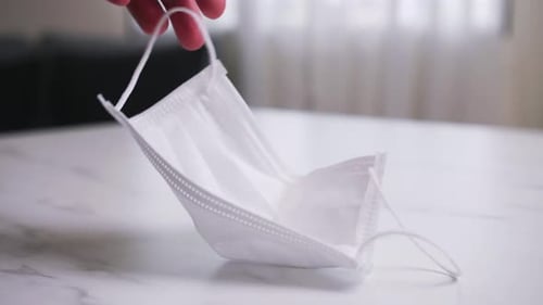 Surgical Mask Resting on a Marble Table