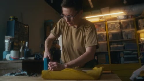Woman Using Staple Gun in Workshop