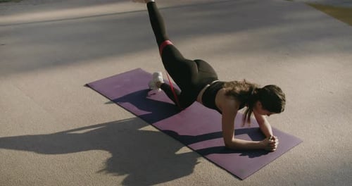Woman Exercising with Resistance Band in Urban Setting