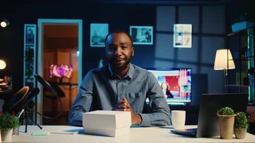Enthusiastic Man Unboxing New Smartphone in Studio