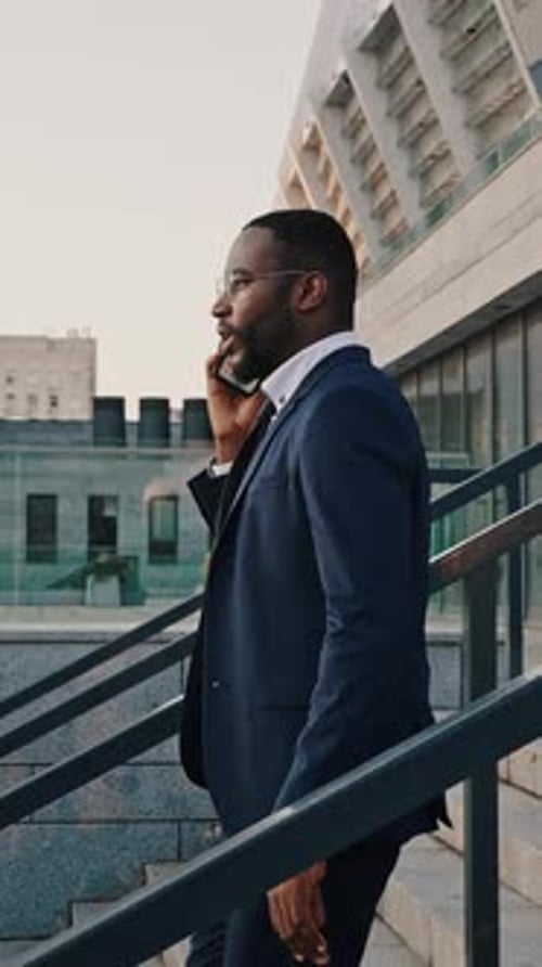 Business on Go Busy African American Employee Talking with Partners Via Cellphone Moving Down on
