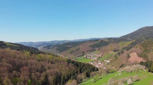 Aerial pedestal of a small village in a valley surrounded by the Blackforest, Germany