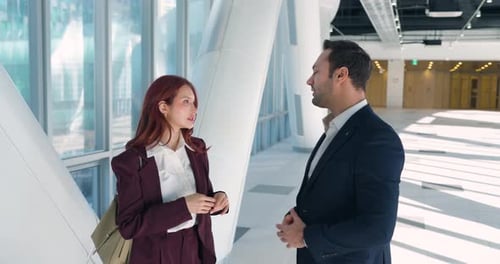 Business Colleagues Having Friendly Conversation in Modern Office Corridor
