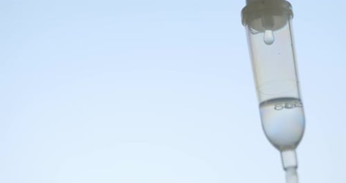 Close up of saline solution dripping for patient on white background.