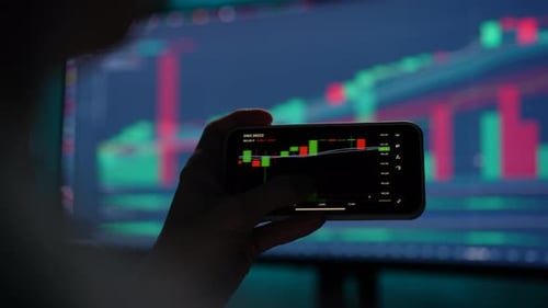 Cropped Shot of Male Stock Trader Checking Stock Market Data Using Mobile Phone Scrolling Touching