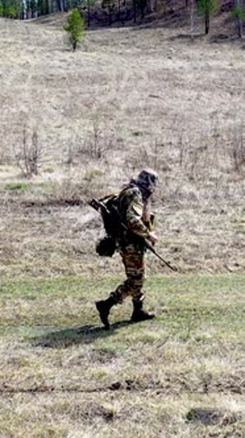 Lonely Tired Soldier Walking Along the Forest Road