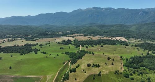 Beautiful Countryside with Green Fields and Lush Mountains AERIAL