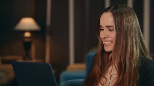 Excited Business Woman Reading Good News on Laptop Computer in Hotel At