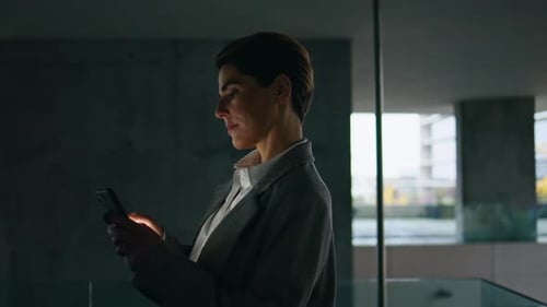 Dark Woman Using Smartphone On Office Terrace. Focused Businesswoman Scrolling Mobile Phone Socia...