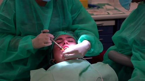 Dentist applying anaesthesia to lower jaw in patient. Close up
