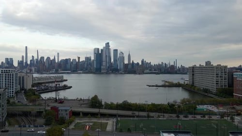 Aerial drone view approaching the Hudson yards district, from Jersey city - birds in frame
