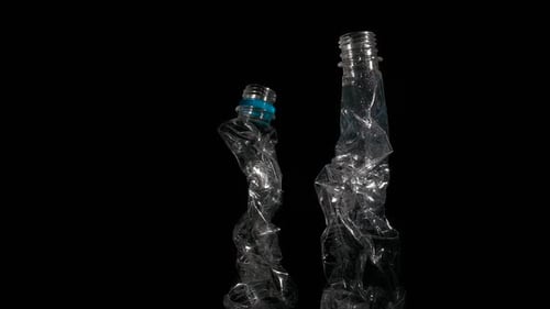Crumpled Plastic Bottles on Black Background, Close Up