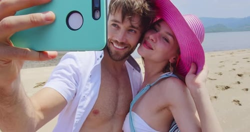 Carefree couple capturing memories on a Thailand beach in beautiful slow motion