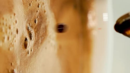 Close Up of Brown Beverage Being Poured in Glass
