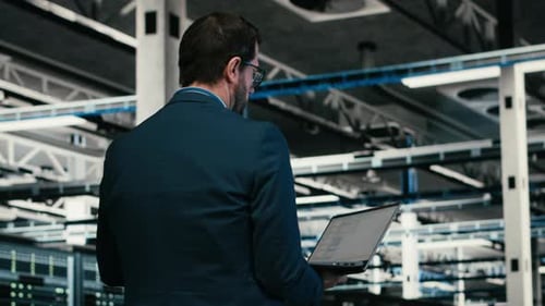 Software Developer in Data Center Using Laptop to Code