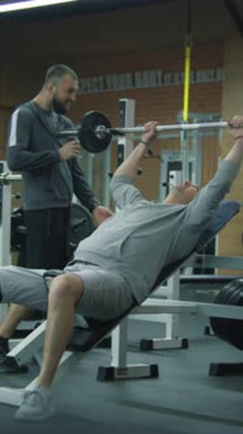 Man with Prosthetic Leg Working Out with Trainer